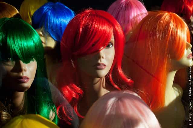 Shop mannequins wearing wigs are displayed in a hair and beauty store in Brixton