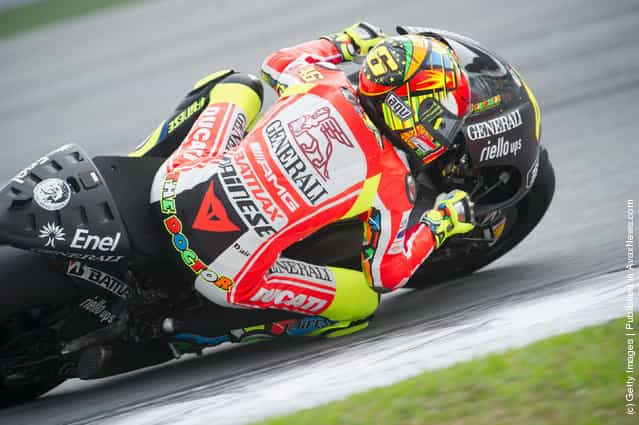 Valentino Rossi of Italy and and Ducati Marlboro Team rounds the bend during the third day of MotoGP testing at Sepang Circuit