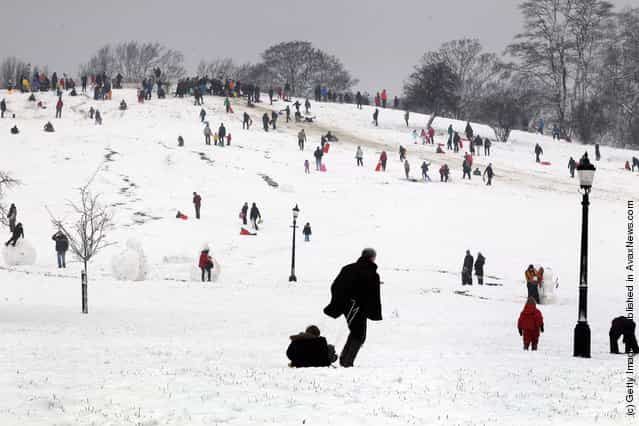 People enjoy the snow on Primrose Hill