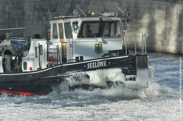 The icebreaker Seeloewe (Sea Lion) makes its way through ice on the Spree river