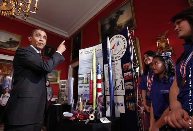 U.S. President Barack Obama talks with Ana Nieto (R) of Presidio, Texas, team leader of Team America Rocketry Challenge (TARC) along with teammates Janet Nieto (2nd L) and and Gwynelle Condino, while touring student science fair projects on exhibit in the State Dining Room at the White House