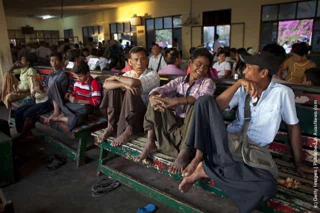 Burmese men chat in the waiting room before boarding a Yangon ferry