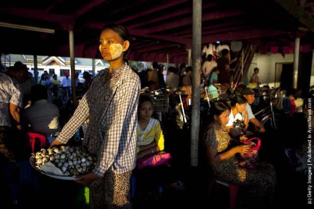 Burmese pack a Yangon ferry heading home during rush hour as a woman sells boiled bird eggs in Yangon, Myanmar