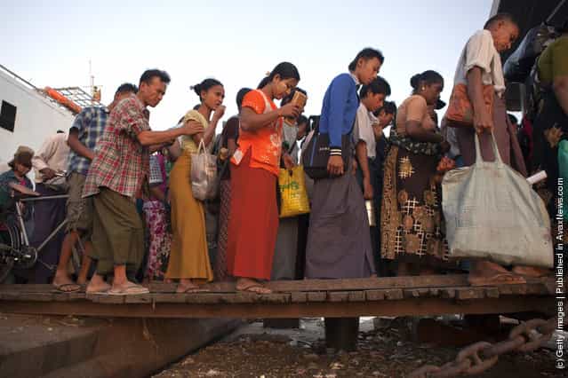 Burmese disembark from a Yangon ferry at rush hour in Yangon, Myanmar