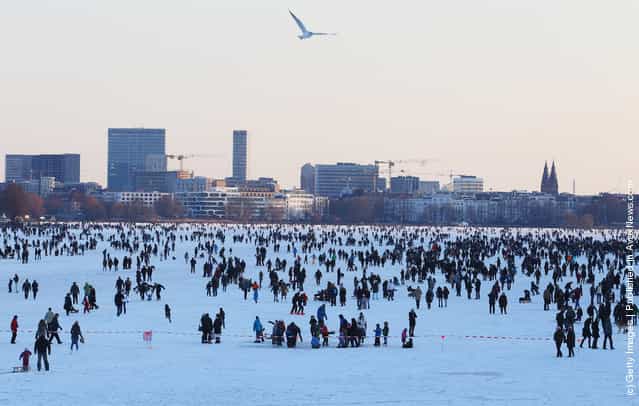 Thousands of people stay on the frozen Aussenalster river during the Alstervergnuegen on February