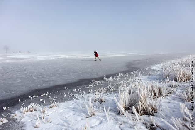 Enthusiasts skate on a frozen fen in sub-zero temperatures