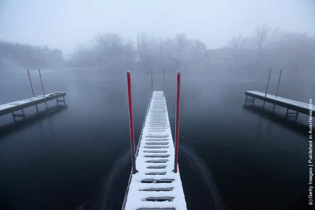 A snow-covered jetty in a partially frozen River Great Ouse