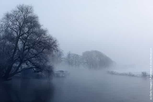 Mist rises from the partially frozen Great Ouse river