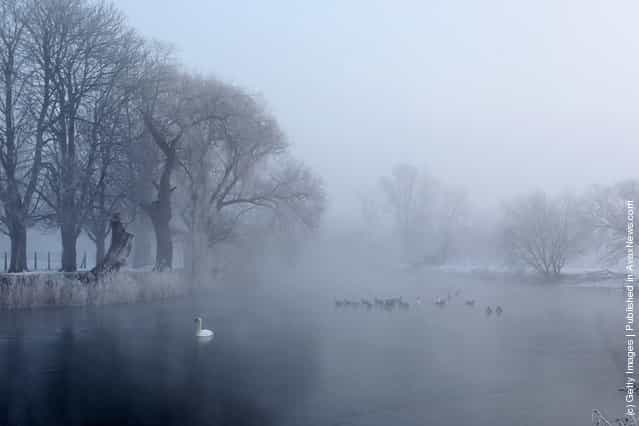 Mist rises from the partially frozen Great Ouse river