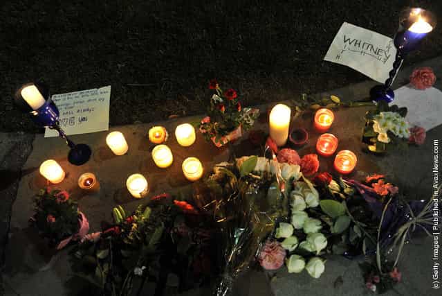 Flower tributes are left at the Beverly Hilton Hotel in the early hours