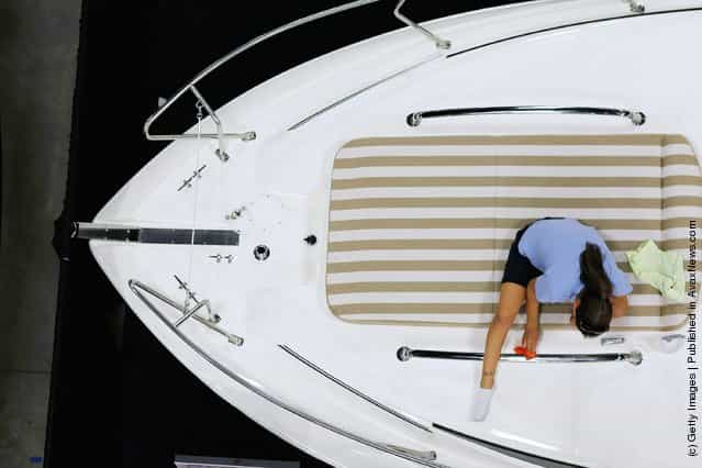 Workers prepare boats for tomorrows opening day of the four day long Progressive Insurance Miami International Boat Show at the Miami Beach Convention Center