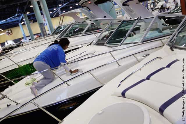 Workers prepare boats for tomorrows opening day of the four day long Progressive Insurance Miami International Boat Show at the Miami Beach Convention Center