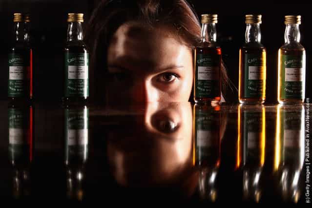 Victoria Kasperovich, an employee at McTears Auctioneers, views a very rare collection of five Cadenhead Irish whiskey miniatures