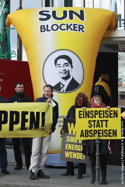  Activists protesting cuts in subsidies to solar power in Germany protest outside the building where Vice Chancellor and Economy Minister Philipp Roesler and Environment Minister Norbert Roettgen were announcing the cuts