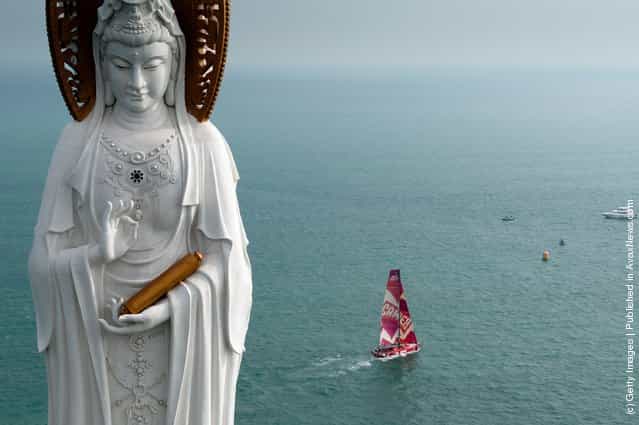 CAMPER with Emirates Team New Zealand, skippered by Chris Nicholson from Australia, sails past the Guan Yin of the South Sea of Sanya, at the start of leg 4 of the Volvo Ocean Race 2011-12