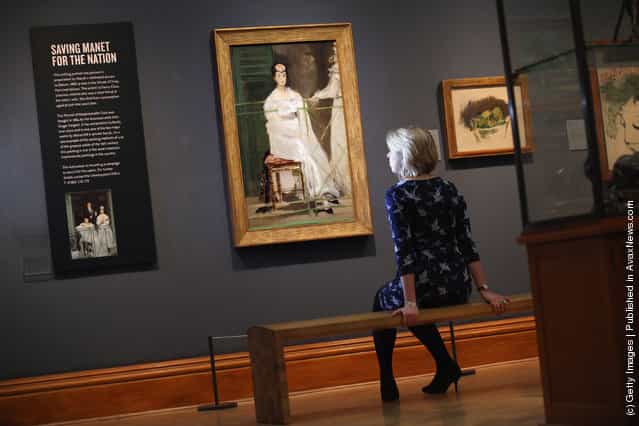 A woman sits near a painting by Edouard Manet entitled Portrait of Mademoiselle Claus from 1868 in the Ashmolean Museum