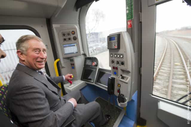 Prince Charles, Prince of Wales, is shown how to drive a London Underground tube train during a visit to Bombardier Transportation, where he toured the facilities and met employees working on London Underground tube trains