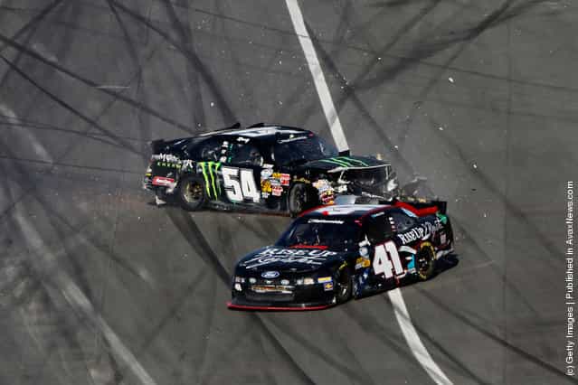 Kyle Busch, driver of the #54 Monster Energy Toyota, and Blake Koch, driver of the #41 Rise Up and Register Ford, spin after being involved in a last lap on track incident during the NASCAR Nationwide Series DRIVE4COPD 300 at Daytona International Speedway