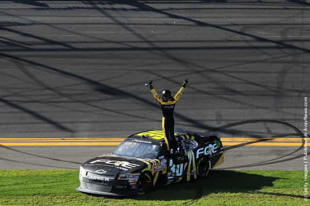James Buescher, driver of the #30 Fraternal Order of Eagles Chevrolet, celebrates on top of his car after winning the NASCAR Nationwide Series DRIVE4COPD 300 at Daytona International Speedway