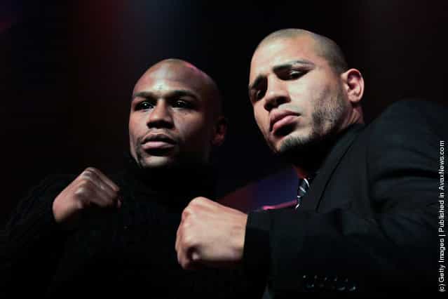 (L) Floyd Mayweather and (R) Miguel Cotto pose at a press conference to promote their upcoming fight on May 5 at the MGM Grand in Las Vegas at the The Apollo Theater