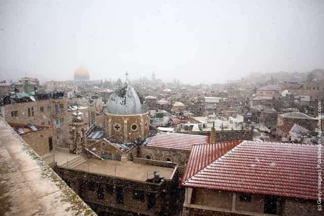 Snow dusts roofs as it falls over the old city houses on March 2, 2012 in Jerusalem, Israel