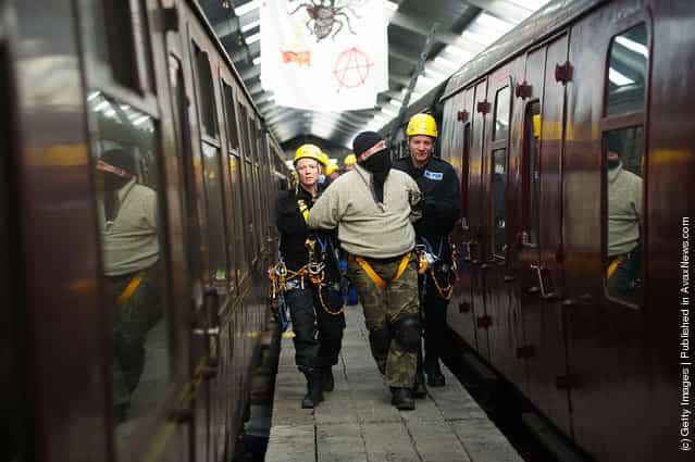 Police take part in a role play exercise as they clear a protest on top of a train during training in Oxenhope, England