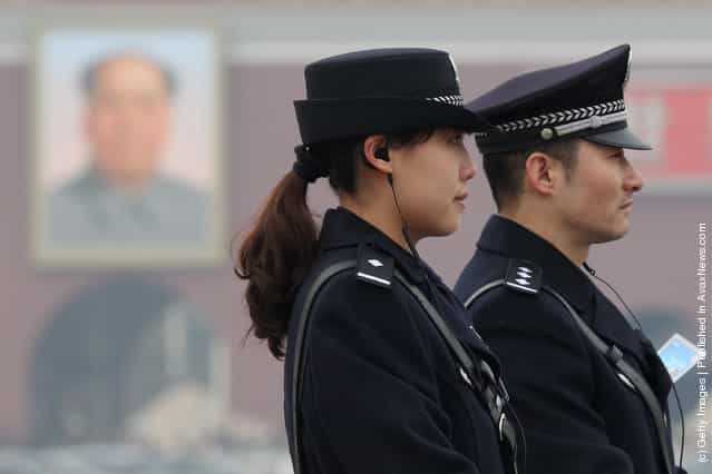 A policeman and a policewoman guard after the opening ceremony of the Chinese People's Political Consultative Conference at the Tiananmen Square on March 3, 2012 in Beijing, China