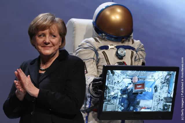 German Chancellor Angela Merkel smiles during a live hook-up with astronaut Andre Kuipers on the ISS space station at the opening ceremony of the CeBIT 2012 technology trade fair on March 5, 2012 in Hanover, Germany