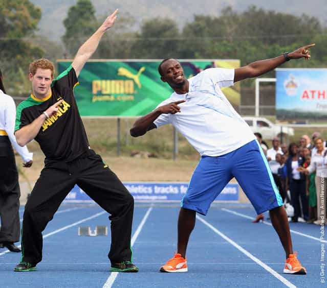 Prince Harry poses with Usain Bolt at the Usain Bolt Track at the University of the West Indies on March 6, 2012 in Kingston