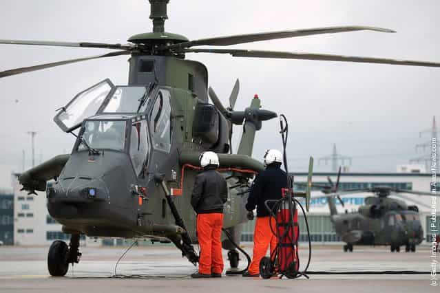 Workers check an Eurocopter Tiger military attack helicopter at the Eurocopter plant