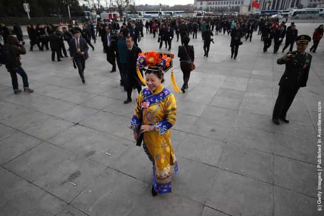 A female ethnic minority delegate wearing a traditional costume arrives at The Great Hall Of The People before the second plenary meeting of the National Peoples Congress (NPC)