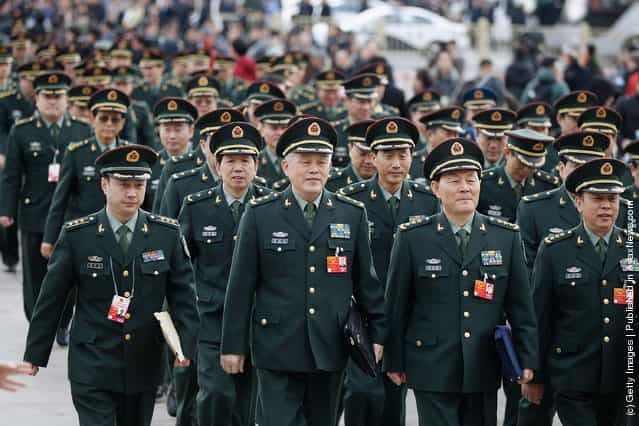 Chinese military delegates arrive at The Great Hall Of The People before the second plenary meeting of the National Peoples Congress (NPC)