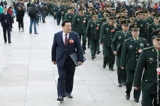 A delegate looks Chinese military delegates arriving at The Great Hall Of The People before the second plenary meeting of the National Peoples Congress (NPC)