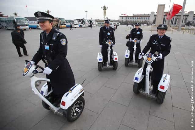 Police officers on motorized vehicles patrol at Beijings Tiananmen Square outside The Great Hall Of The People before the second plenary meeting of the National Peoples Congress (NPC)