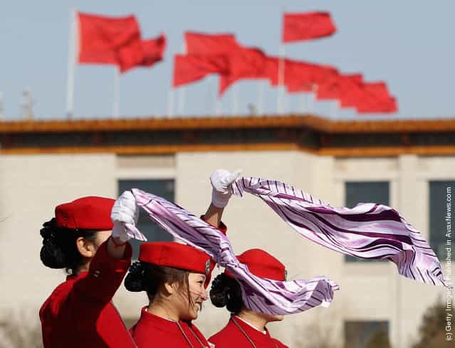 Hostesses pose for photos in windy during the third plenary meeting of the 11th National Committee of the Chinese Peoples Political Consultative Conference (CPPCC) at The Great Hall Of The People
