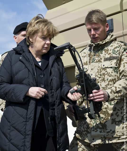 German Chancellor Angela Merkel talks to a soldier during her visit at Camp Marmal in Mazar-i-Sharif, Afghanistan