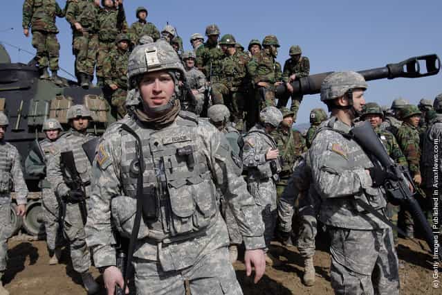 U.S. soldiers from 145th Field Artillery Battalion deployed from the United States and South Korean soldiers, participate in the Foal Eagle training exercise at firing point 180 at the Rodriguez Live Fire Range on March 15, 2012 in Pocheon, South Korea