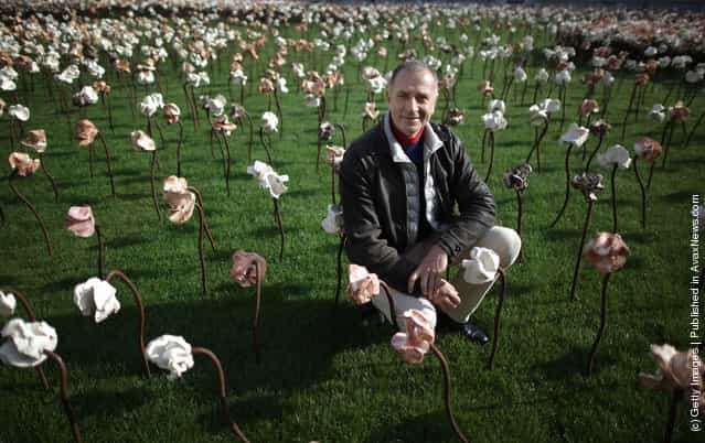 London based Chilean artist Fernando Casasempere poses with his Out of Sync art installation on a grass meadow at Somerset Housein London