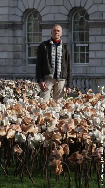 London based Chilean artist Fernando Casasempere poses with his Out of Sync art installation on a grass meadow at Somerset Housein London