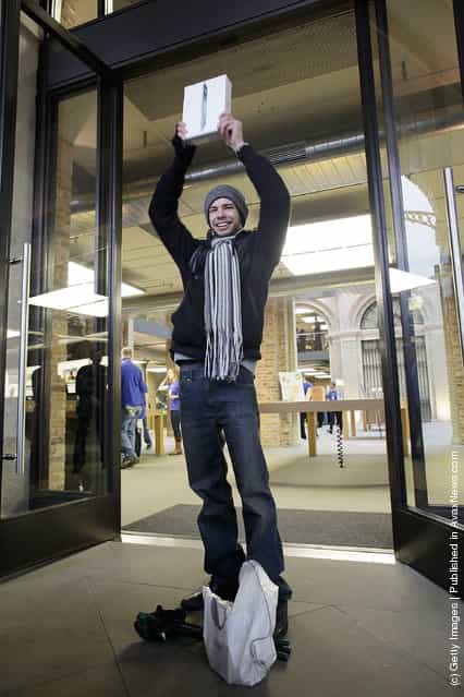 Craig Jobbins, first buyer of the new iPad to leave the Apple Store, poses for photographers in Covent Garden on March 16, 2012 in London