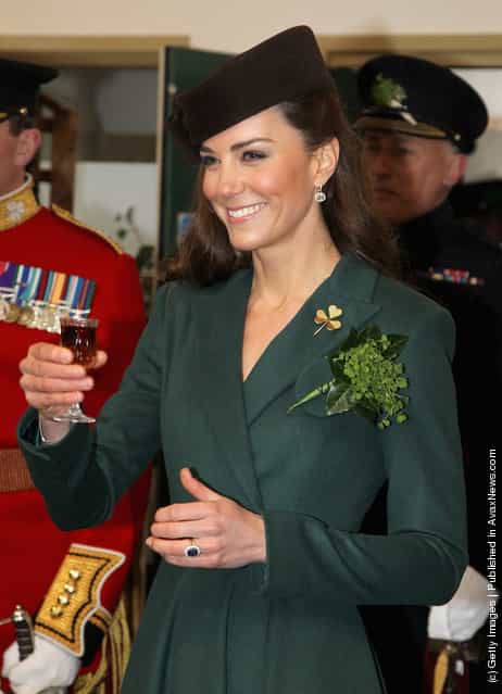 Catherine, Duchess of Cambridge holds a glass of Harvey's Bristol Creme in the Junior's Mess as she visits Aldershot Barracks on St Patrick's Day