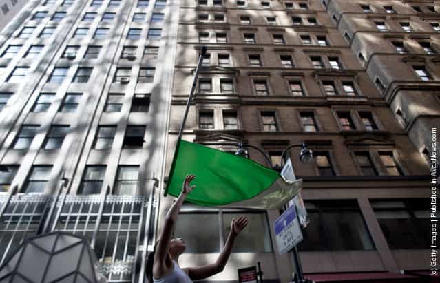 A woman throws a flag while marching during the 251st annual St. Patricks Day Parade March 17, 2012 in New York City