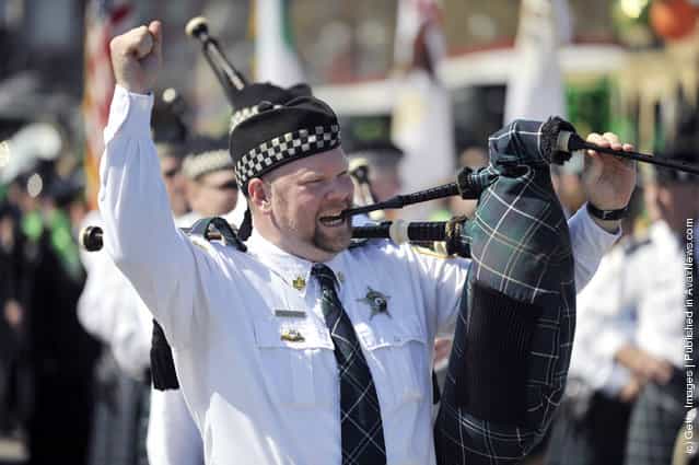  A member of the Bagpipes and Drums of the Chicago Police Emerald Society calls out a tune at the St. Patricks Day parade