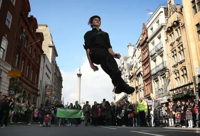 A traditional Irish dancer leaps during a St Patricks day parade on March 18, 2012 in London