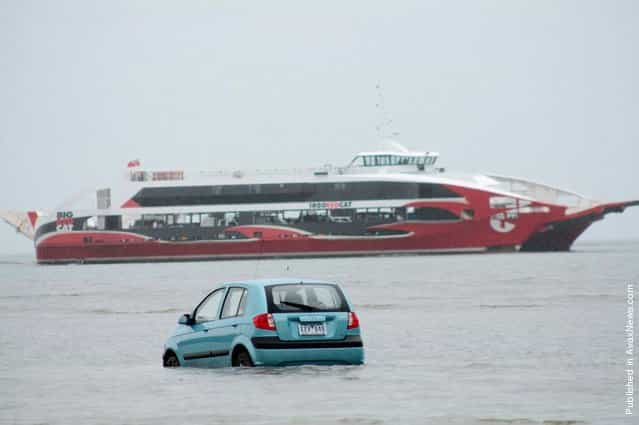 Three Japanese tourists had to abandon plans to drive to Stradbroke Island off the Queensland coast when their hire car became bogged in mangrove mud, on March 15, 2012 near Stradbroke Island, Australia