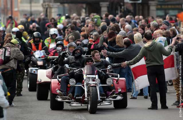 Bikers passes along the High Street on March 18, 2012 in Royal Wootton Bassett, England