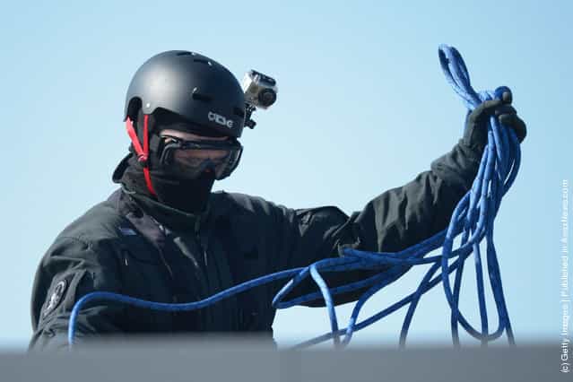 A Member of Germanys elite police unit, the Spezialeinsatzkommando, or SEK, packs up his equipment after demonstrating an abseil deployment from a helicopter during a media event