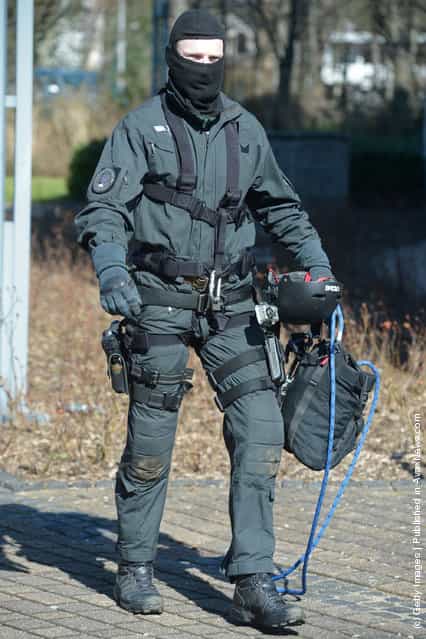 A Member of Germanys elite police unit, the Spezialeinsatzkommando, or SEK, leaves the building after demonstrating an abseil deployment from a helicopter during a media event