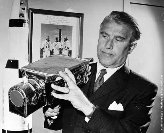 1971: German-born American rocket pioneer and NASA administrator Dr Wernher von Braun (1912 - 1977) examines the camera which is to be used for the Apollo 15 Lunar Landing Mission