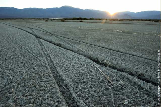 Tire tracks cross the soft mud of the shore of the Salton Sea in an area where a controversial development would create a new town for nearly 40,000 people on the northwest shore of the biggest lake in California, the Salton Sea